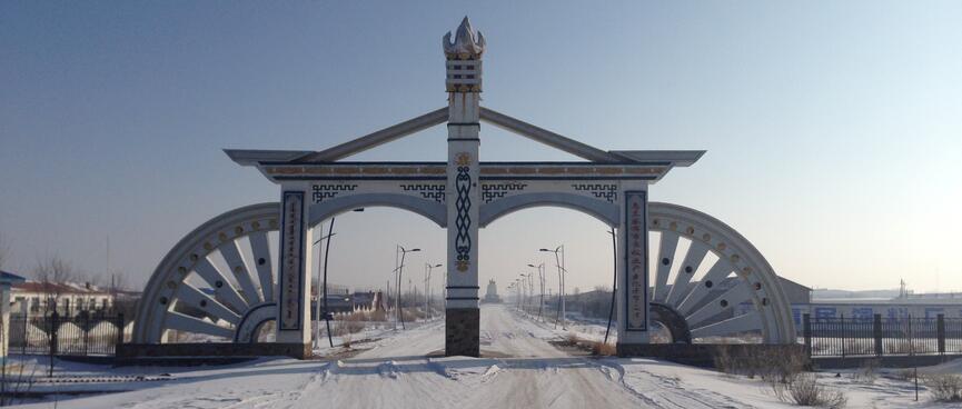 Two-lane gateway with quarter wagon wheels on either side.
