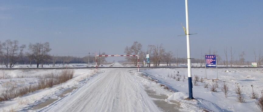 A snowy country road extends to the horizon.