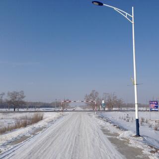 A snowy country road extends to the horizon.