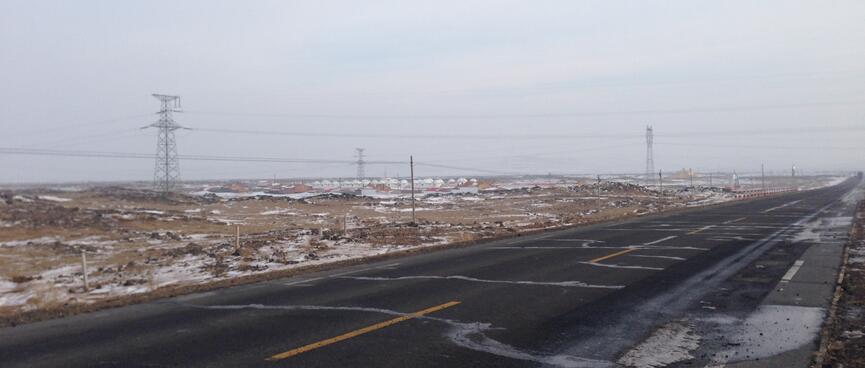 A cluster of white roofs in the distance.