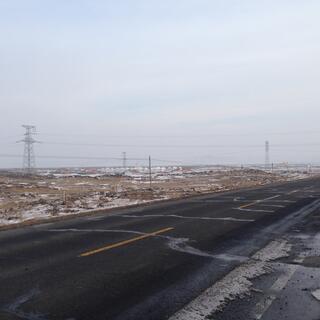 A cluster of white roofs in the distance.