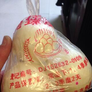 Yellow skinned friut in a plastic bag.