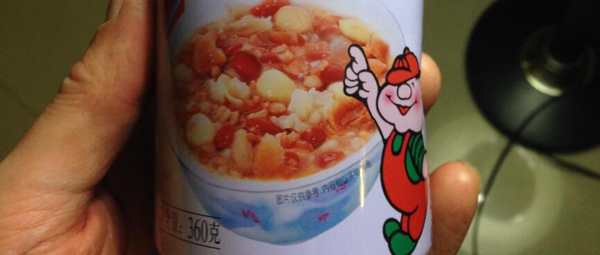 A tall narrow can showing a picture of vegetables in a bowl.