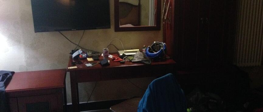 The writing desk is covered in electronics.