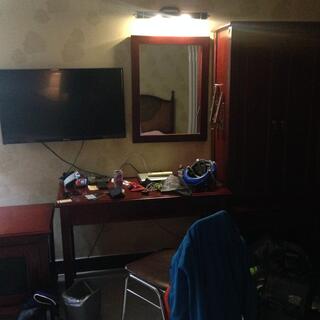 The writing desk is covered in electronics.