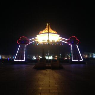 A large archway is outlined in white and red neon.