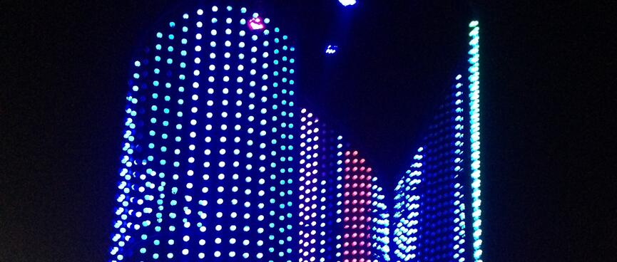 Rows of white red and blue lights in the shape of a fish.