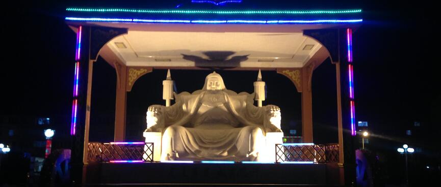 Statue of Genghis Khan seated on a throne.