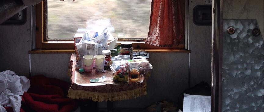 A small table is crowded with various bags and containers.