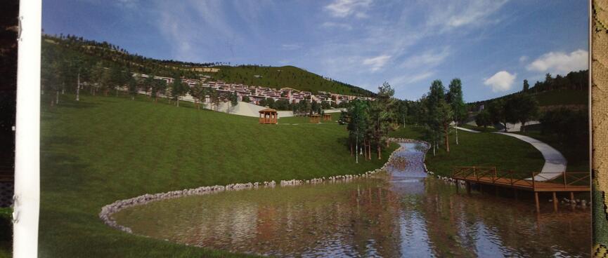 Brochure page showing modern low rise apartments on the grassy bank above a round lake.
