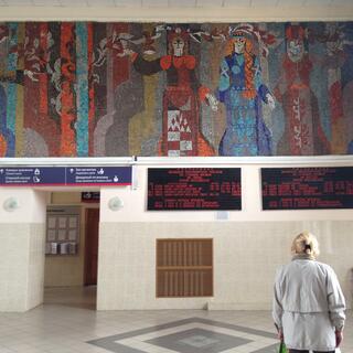 A colourful tiles mural depicts women in different outfits.
