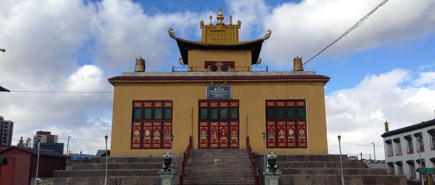 Muddy yellow temple with upturned eaves.