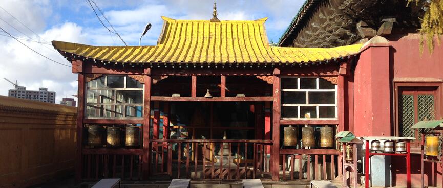 Open temple building with a yellow ridged roof.