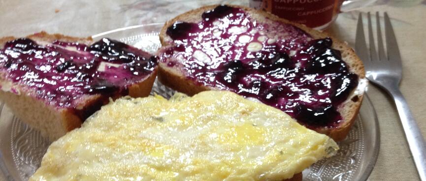 Omelette and jam on pieces of bread.