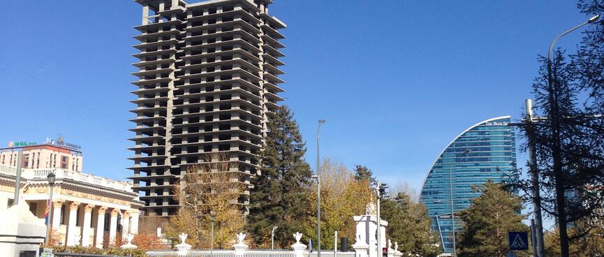 Rectangle and circular high rises soar above low rise buildings.