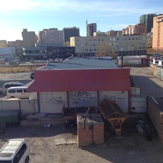 A graffiti sketch in an industrial area depicts a man saying 'What?'.