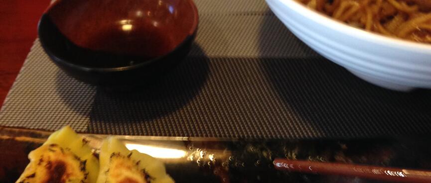 Bowls and trays of Japanese food.