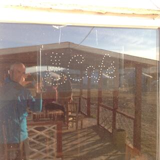 Our group is reflected in the window of the camp cafe.