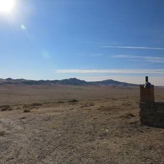 Barren steppes and distant hills.