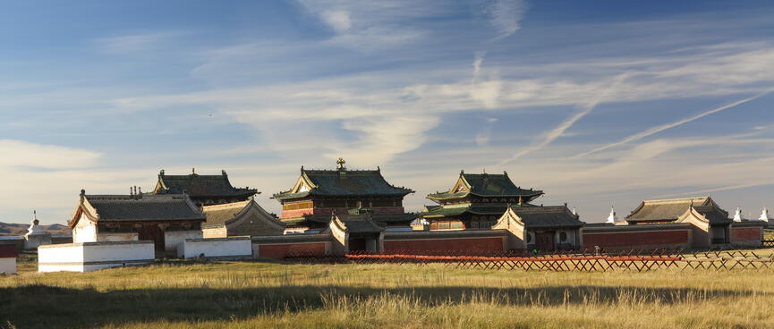 A walled area containing two story buildings with smiling eaves.