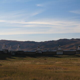 White stone monuments at equal intervals on the perimeter wall.