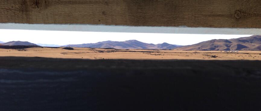 A thin slit in the toilet door provides a panoramic view of the landscape.