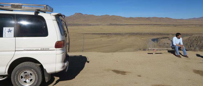 Our driver sits and waits next to the van.