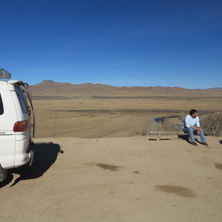 Our driver sits and waits next to the van.