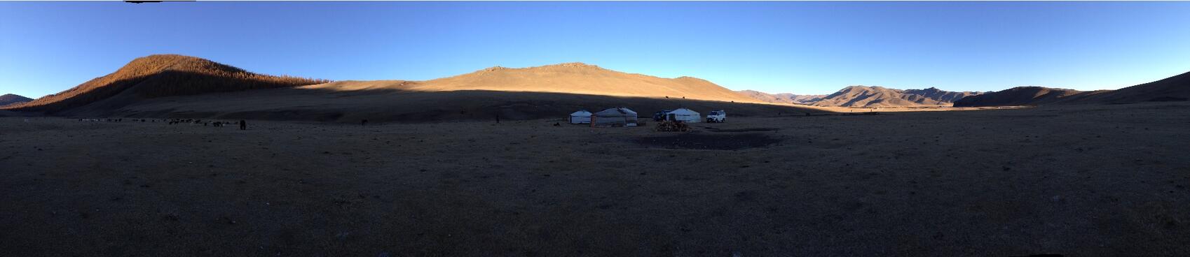 A sliver of sunlight highlights distant hills.
