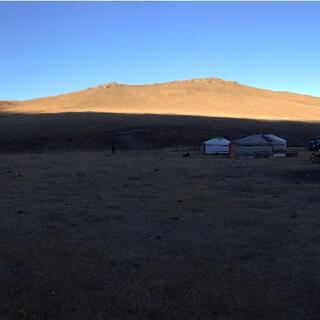 A sliver of sunlight highlights distant hills.