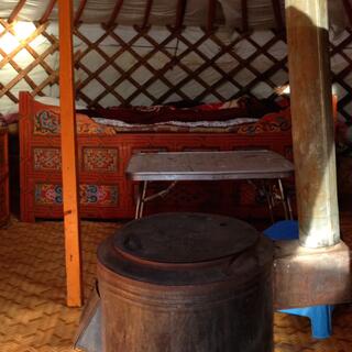 Floral bedspreads on top of ornate wooden bed frames.