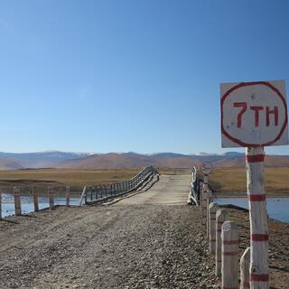 A red and white sign reads '7 T H'.