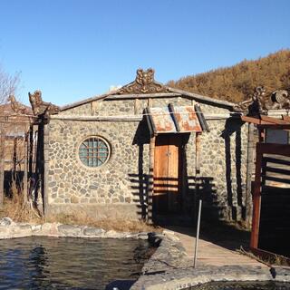 A stone building and two hot pools.