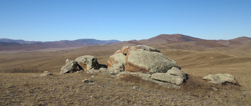 A small pile of rocks complement the hilly horizon.