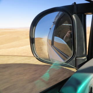 Reflections in the vanʼs wing mirror.