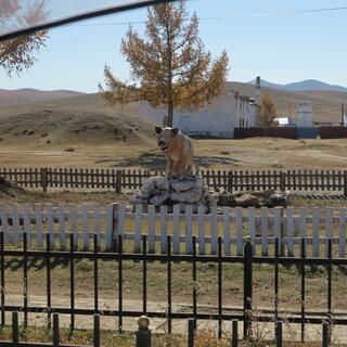 A menacing statue of a white wolf.