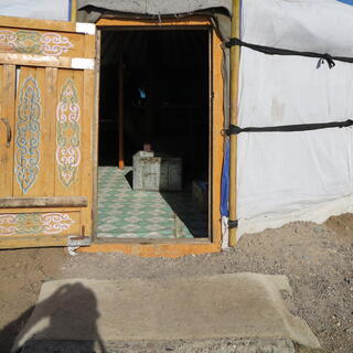 The ornate door of our ger is wide open.