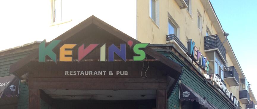 Futuristic multi-coloured lettering above a restaurantʼs entranceway.