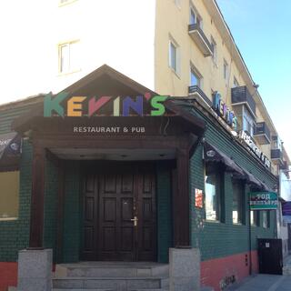 Futuristic multi-coloured lettering above a restaurantʼs entranceway.
