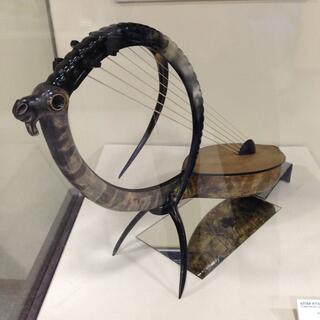 An ancient bow harp resembles an antelope with curved tusks.