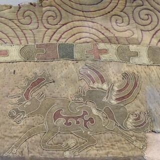 A sewn quilt features two running reindeer.