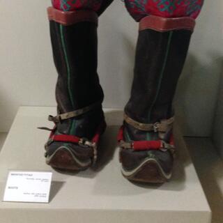 A pair of felted boots are black red and brown, with stitched red liners.