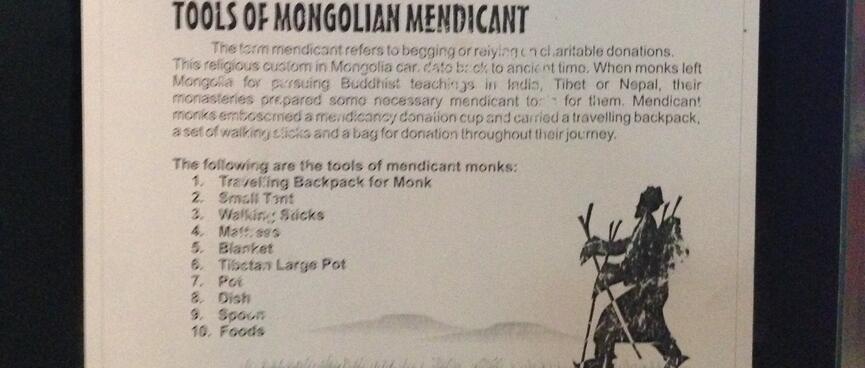 A poster listing the pack list of begging monks - pack, tent, sticks, blanket, mattress, pots, dish, spoon, food.