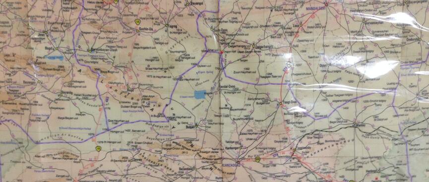 A laminated map is covered in a jumble of snaking lines.