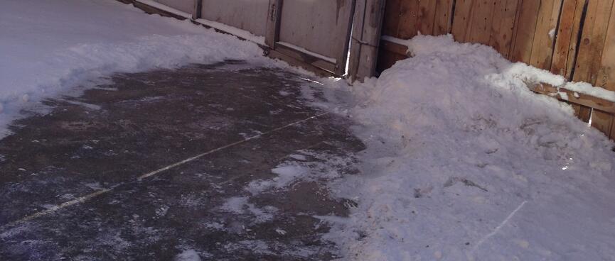 A cleared path through snow in the hostel courtyard.