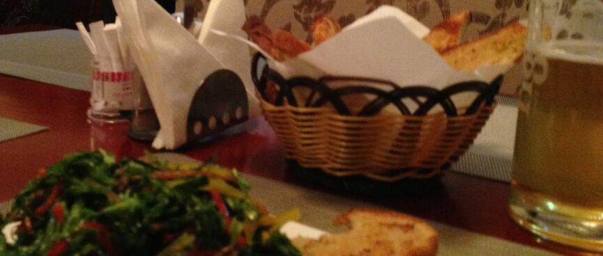 Salad, toast and beer in the paisley dining booth.