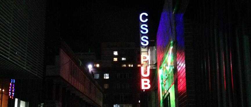 A neon sign reads 'CSS PUB'.