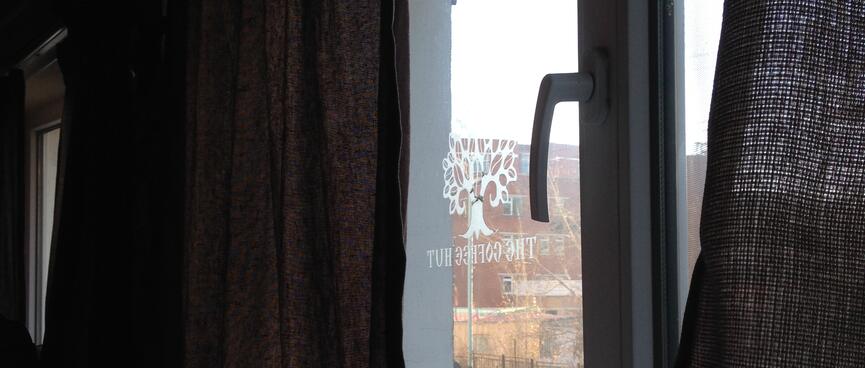 Brick buildings and a reverse stencil of The Coffee Hut.