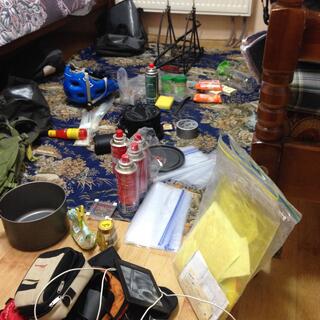 Camping gear covers the floor of my room at the hostel.