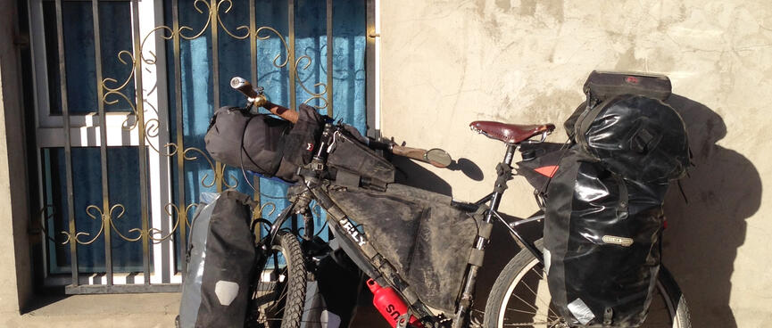 The rear rack of my touring bicycle is piled high with gear.